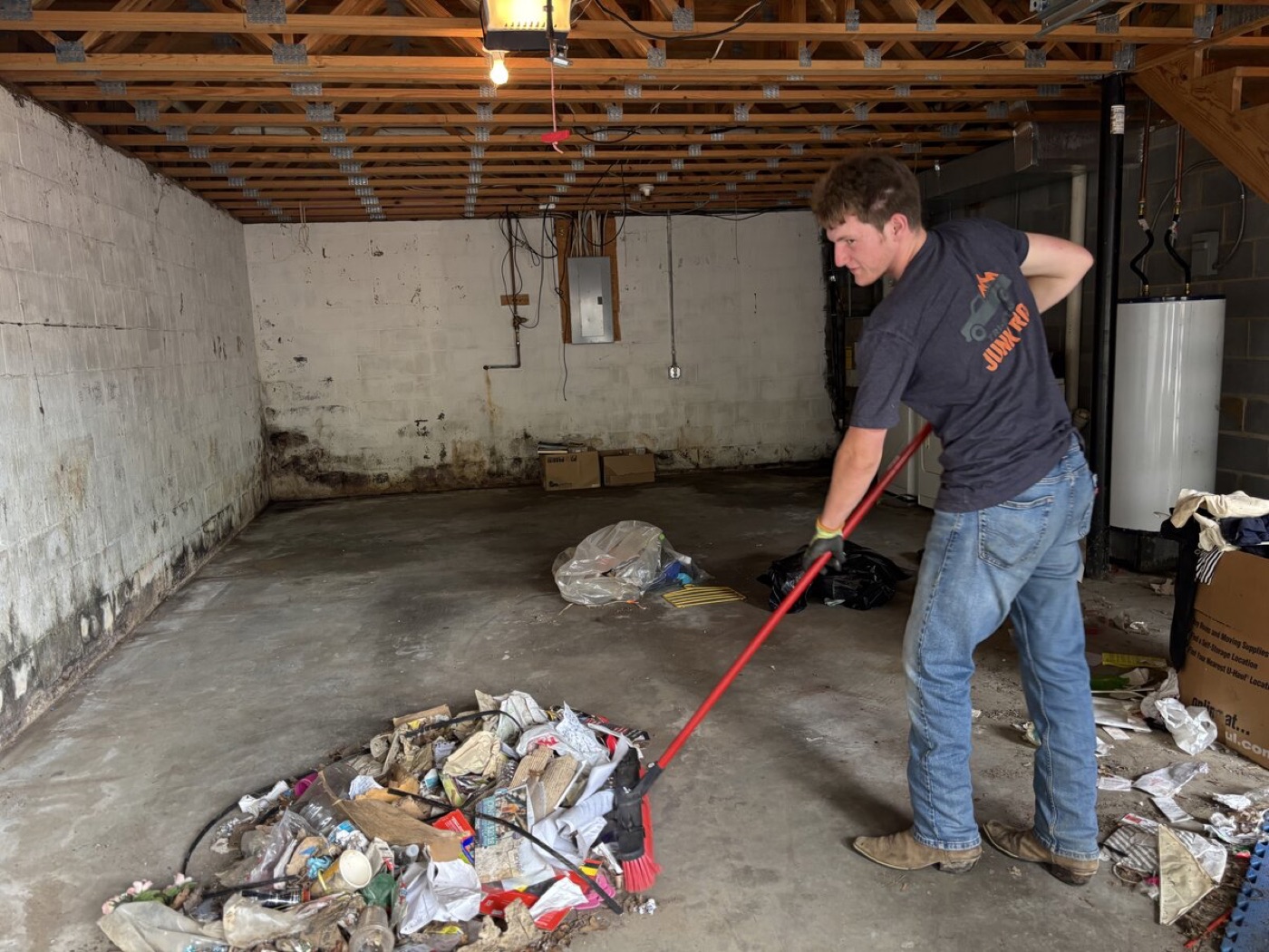 TriCities Junk Pros crew sweeping after a garage cleanout